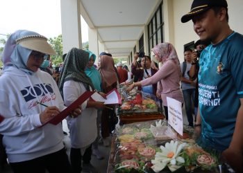 Bupati Merlan S. Uloli bersama tim juri saat melakukan penilaian lomba merangkai buah di stand Puskesmas Suwawa Tengah, Jumat (19/1/2024). (F.AKP/Diskominfo)