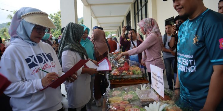 Bupati Merlan S. Uloli bersama tim juri saat melakukan penilaian lomba merangkai buah di stand Puskesmas Suwawa Tengah, Jumat (19/1/2024). (F.AKP/Diskominfo)