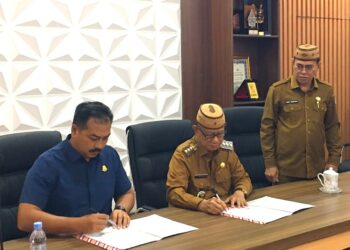 Bupati Bone Bolango, Ismet Mile didampingi Sekda Iwan Mustapa pada kegiatan Penandatanganan NPHD dan BAST tentang Perjanjian Hibah Tanah untuk Pembangunan Rumah Susun Kejari Bone Bolango yang digelar di Ruang Rapat Bupati, Selasa (28/7/2026). (F.Indra/Diskominfo)